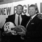 FILE - In this April 11, 1984, file photo, newly signed New England Patriots football player Irving Fryar, left, poses with Patriots coach Ron Meyer during a press conference in Foxborough, Mass. From SMU?s ?Pony Express? to the NFL?s infamous ?Snowplow Game,? former college and professional football coach Ron Meyer was in the middle of some of the game?s most controversial and colorful teams and moments in the 1980s. Meyer died Tuesday, Dec. 5, 2017, in Austin, Texas, at age 76. (AP Photo/Ted Gartland, File)