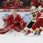 Boston Bruins left wing Brad Marchand (63) scores against Detroit Red Wings goalie Jimmy Howard (35) during overtime of an NHL hockey game Wednesday, Dec. 13, 2017, in Detroit. Boston won 3-2. (AP Photo/Paul Sancya)