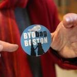 Gretchen Dietz of West Roxbury held a sticker in favor of Boston?s proposed plastic bag ban.