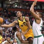 Marcus Smart picks up a charge on Utah?s Alec Burks during the second quarter Friday.