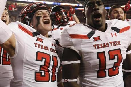 AUSTIN, TX - NOVEMBER 24: Justus Parker #31 of the Texas Tech Red Raiders and Kolin Hill #13 celebrate after the game against the Texas Longhorns at Darrell K Royal-Texas Memorial Stadium on November 24, 2017 in Austin, Texas. (Photo by Tim Warner/Getty Images)
