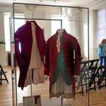 The coat on the right is the original crimson jacket worn by John Hancock. The one on the left is a replica. 