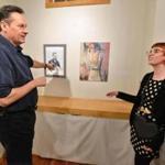 Artist Gary McManus, a guard at the Museum of Fine Arts, shows his portrait of late artist and colleague Zlatko Fedotov to Fedotov?s daughter, Nina, and her partner, Michael Richards, at Gallery 263 in Cambridge.  