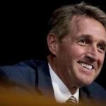 FILE - In this Oct. 31, 2017, file photo, Sen. Jeff Flake, R-Ariz., asks questions during a Senate Committee on Capitol Hill in Washington. Arizona jurors who will decide a malicious-prosecution trial against former Sheriff Joe Arpaio were told Tuesday, Dec. 5, 2017, that one of Sen. Flake's sons suffered from depression as a result of a now-dismissed animal cruelty case that the lawman brought against him. (AP Photo/Andrew Harnik, File)
