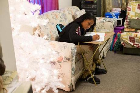 Ashantie Lopez, 11, works on her homework in the living room of her aunt's home in Springfield, Massachusetts on December 6, 2017. Lopez recently arrived from Rio Grande, Puerto Rico to stay with her aunt while the island recovers from the devastation caused by hurricane Maria. She is one of many school aged children who recently arrived in Springfield from Puerto Rico as a result of the storm. Matthew Healey for The Boston Globe (METRO)
