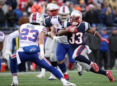 Patriots player Dion Lewis cut back on Bills player Micah Hyde in the fourth quarter.
