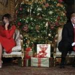 President Donald Trump and first lady Melania Trump speak on the phone with children as they track Santa Claus' movements with the North American Aerospace Defense Command (NORAD) Santa Tracker on Christmas Eve at the president's Mar-a-Lago estate in Palm Beach, Fla., Sunday, Dec. 24, 2017. (AP Photo/Carolyn Kaster)