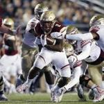 FILE - In this Oct. 27, 2017, file photo, Boston College running back AJ Dillon (2) carries the ball against Florida State defensive back Derwin James (3) during the first half on an NCAA college football game in Boston. Dillon was selected to the AP All-Conference ACC team announced Tuesday, Dec. 5, 2017. (AP Photo/Michael Dwyer, File)