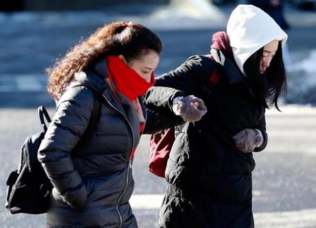 A pair held hands as they passed over an icy patch in Copley Square. 
