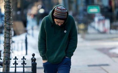 A man tried to keep warm while walking down Newbury Street in Boston Wednesday.  
