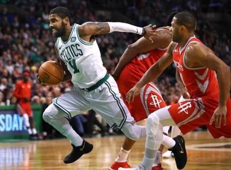 Boston-12/28/2017 Boston Celtics vs Houston Rockets- Celtics Kyrie Irving powers past Rockets Eric Gordon as he drives to the basket for two points in the 1st qtr. John Tlumacki/Globe staff (sports)

