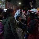 Evacuees at the scene of a deadly fire on Thursday nigh at a five-story apartment building in the Belmont section of the Bronx. 