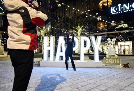 Kevin Morales of Revere took a photo of Rachel Walker of Stoneham as she posed near an ice sculpture in the Seaport.
