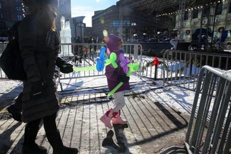 The first customers of the balloon man in Copley Square, 6-year-old Eloise Corrigan and her mom Julia, held their ?flowers.?
