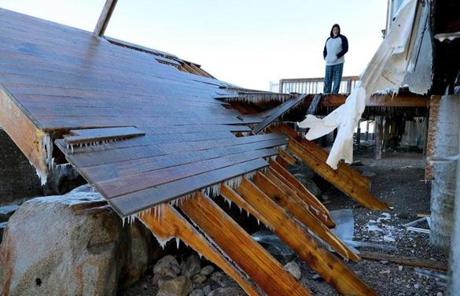 STORM SLIDER Sci-01/05/18Jeff Chick rode out the storm in the ocean-front home on Oceanside Drive that he rents, but the deck was ripped off the house by the crasing waves over the seawall. Cleanup was underway in the oceanfront sections of scituate after Thursday's blizzard and high tide flooded much of the area. John Tlumacki\Globe staff(metro)
