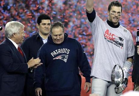 New England Patriots quarterback Tom Brady, right, holds the AFC championship trophy beside team owner Robert Kraft, left, honorary captain Tedy Bruschi, second from left, and head coach Bill Belichick after the AFC championship NFL football game, Sunday, Jan. 22, 2017, in Foxborough, Mass. The New England Patriots defeated the the Pittsburgh Steelers 36-17 to advance to the Super Bowl. (AP Photo/Matt Slocum)
