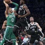 Boston Celtics forward Jayson Tatum (0) goes to the basket against Brooklyn Nets forward DeMarre Carroll (9) during the second half of an NBA basketball game Saturday, Jan. 6, 2018, in New York. The Celtics won 87-85. (AP Photo/Mary Altaffer)
