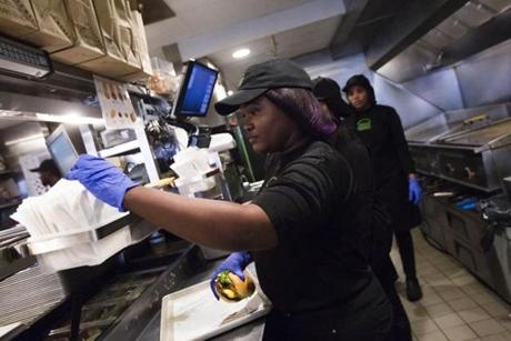 Djennyfer Joseph, who is from Haiti, filled an order at the Shake Shack on Newbury Street.
