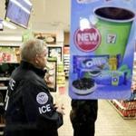 US Immigration and Customs Enforcement agents serve an employment audit notice at a 7-Eleven convenience store Wednesday in Los Angeles. 