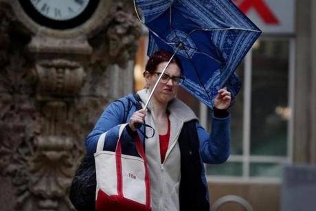 Boston, MA- January 12, 2018: Ella Bessmer battles with her umbrella while walking on Washington Street in Boston, MA on January 12, 2018. After last week?s winter storm that deluged coastal areas and blasted snow across New England, followed by a regional thaw, Massachusetts residents are preparing for rains Friday and Saturday that are expected to rapidly melt more snow and cause further flooding before a cold front arrives to refreeze everything. (Globe staff photo / Craig F. Walker) section: metro reporter: 
