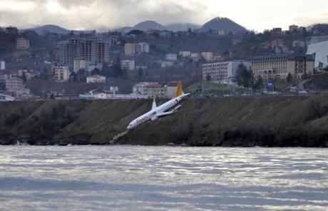 A Boeing 737-800 of Turkey's Pegasus Airlines after skidding off the runway downhill towards the sea at the airport in Trabzon, Turkey, Sunday, Jan. 14, 2018. Trabzon Gov. Yucel Yavuz said all 162 passengers and crew on board were evacuated and safe early Sunday. The cause of the accident was not yet known. (DHA-Depo Photos via AP)
