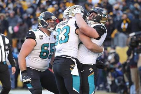PITTSBURGH, PA - JANUARY 14: Tommy Bohanon #40 of the Jacksonville Jaguars celebrates with Ben Koyack #83 and Brandon Linder #65 after a touchdown against the Pittsburgh Steelers during the second half of the AFC Divisional Playoff game at Heinz Field on January 14, 2018 in Pittsburgh, Pennsylvania. (Photo by Rob Carr/Getty Images)
