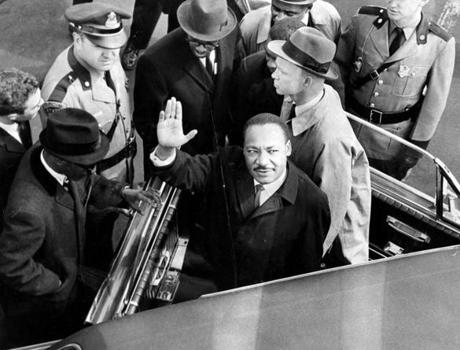 Martin Luther King Jr. entered a car at Logan Airport to ride to the Massachusetts State House on April 22, 1965. King led a march through the city to protest segregated housing conditions and racially imbalanced schools, and also spoke at Boston Common and during his visit.
