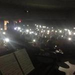 The show must go on. The audience lit the stage with their smartphones when the lights cut out during a middle school play in Hamilton. 