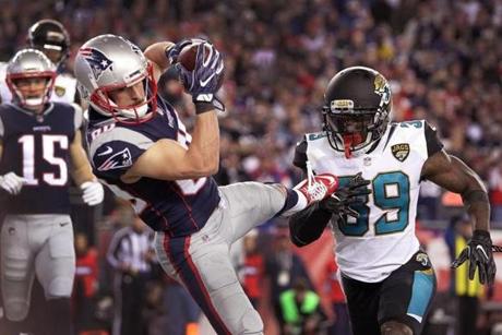 Foxborough, MA 1/21/2018 Patriots Chris Hogan lifts Danny Amendola after he made a touchdown in the fourth quarter. The New England Patriots host the Jacksonville Jaguars in an NFL AFC championship game at Gillette Stadium in Foxborough, Mass., Jan. 21, 2018.(Barry Chin/Globe Staff)
