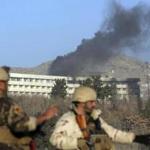 Afghan security personnel stood guard as black smoke rose from the Intercontinental Hotel after an attack in Kabul, Afghanistan, Sunday.  