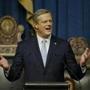 Governor Charlie Baker on Wednesday criticized the way a state agency announced big health insurance changes.