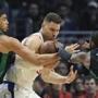 Boston Celtics forward Jayson Tatum, left, and guard Kyrie Irving, right, reach in on Los Angeles Clippers forward Blake Griffin during the first half of an NBA basketball game Wednesday, Jan. 24, 2018, in Los Angeles. (AP Photo/Mark J. Terrill)