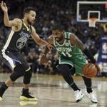 Boston Celtics' Kyrie Irving, right, drives the ball against Golden State Warriors' Stephen Curry duringing the second half of an NBA basketball game Saturday, Jan. 27, 2018, in Oakland, Calif. (AP Photo/Ben Margot)