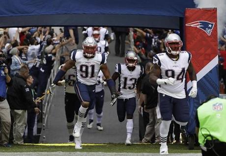 New England Patriots players including defensive tackle Deatrich Wise (91 run out of the tunnel before an NFL football game against the Oakland Raiders, Sunday, Nov. 19, 2017, in Mexico City. (AP Photo/Rebecca Blackwell)
