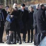 Family and friends gathered outside the funeral service at Saints John and Paul Church in Coventry, R.I.