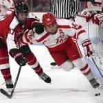 Boston Ma 11/04/17 Boston University Bobo Carpenter skates with the puck with defensive pressure from Northeastern University Matt Filipe during first period action at Agganis Arena. (Matthew J. Lee/Globe staff) topic reporter: Frank Dell'Apa