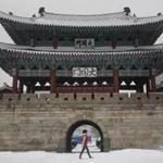 FILE - In this Monday, Jan. 22, 2018 file photo, a North Korean girl walks past the Taedong Gate in Pyongyang, North Korea. Temperatures were forecast to drop below -19 degree Celsius (-2.2 degree Fahrenheit) this week in the North Korean capital. North Korea on Sunday, Feb. 4, slammed President Donald Trump's State of the Union address and said its nuclear capabilities would 