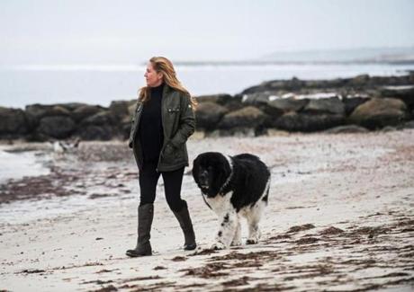 ATF Special Agent SherryAnn Quindley walked with Dublin, her 10-year-old Newfoundland, near Parker River Beach in South Yarmouth in January. 
