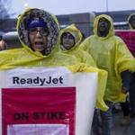 Airport contract workers marched in the rain Wednesday in a picket line near Logan Airport. The workers are attempting to unionize, and their two-day strike ended Thursday.