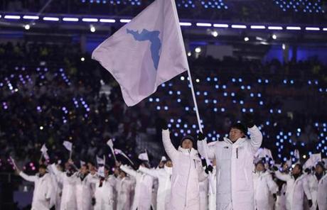 OPENING CEREMONY SLIDER4 North Korea's Hwang Chung Gum and South Korea's Won Yun-jong carries the flag during the opening ceremony of the 2018 Winter Olympics in Pyeongchang, South Korea, Friday, Feb. 9, 2018. (AP Photo/Vadim Ghirda)
