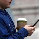 BOSTON, MA - 11/01/2017: A man holding a coffee and a cell phone while walking along Beacon street, oblivious to traffic or other people. People walking and texting, emailing or Instagramming around Boston is becoming a problem for the city. (David L Ryan/Globe Staff ) SECTION: LIFESTYLE TOPIC 03textwalk