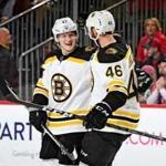 NEWARK, NJ - FEBRUARY 11: Torey Krug #47 is congratulated by his teammate David Krejci #46 of the Boston Bruins after scoring a first period goal against the New Jersey Devils at Prudential Center on February 11, 2018 in Newark, New Jersey. (Photo by Steven Ryan/Getty Images)