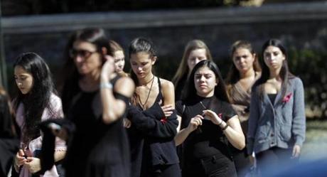 Mourners leave the funeral of Meadow Pollack, a victim of the Wednesday shooting at Marjory Stoneman Douglas High School, in Parkland, Fla., Friday, Feb. 16, 2018. Nikolas Cruz, a former student, was charged with 17 counts of premeditated murder on Thursday. (AP Photo/Gerald Herbert)
