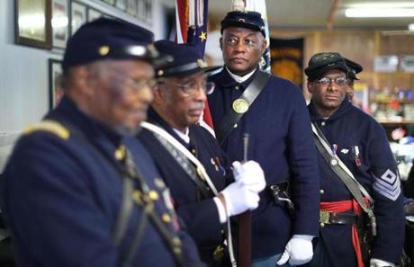 Reenactors with the Massachusetts Volunteer 54th Regiment waited to present the colors in a ceremony at the William E. Carter American Legion Post 16 on Saturday.
