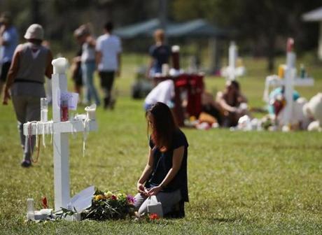 PARKLAND, FL - FEBRUARY 17: A young girl sits at a temporary memorial at Pine Trails Park on February 17, 2018 in Parkland, Florida. Police have arrested former student Nikolas Cruz and charged him with 17 murders for the shooting at Marjory Stoneman Douglas High School on February 14. (Photo by Mark Wilson/Getty Images)
