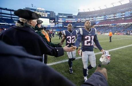 Malcolm Butler and Devin McCourty leave the Gillette Stadium field during a game in November.
