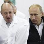 FILE - In this Monday, Sept. 20, 2010 file photo, businessman Yevgeny Prigozhin, left, shows Russian President Vladimir Putin, around his factory which produces school means, outside St. Petersburg, Russia. One of those indicted in the Russia probe is a businessman with ties to Russian President Vladimir Putin. Prigozhin is an entrepreneur from St. Petersburg who's been dubbed 