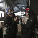 American freestyle skier Gus Kenworthy (left) and his boyfriend Matthew Wilkas held dogs Friday at a dog meat farm in Siheung, South Korea.