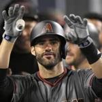 FIL - In this Sept. 4, 2017, file photo, Arizona Diamondbacks' J.D. Martinez gestures toward the camera as he stands in the dugout after hitting his fourth home run of the game in the ninth inning of a baseball game against the Los Angeles Dodgers, in Los Angeles. Perhaps 100 free agents still seek contracts as the start of spring training workouts on Feb. 14 draws near, a group that includes J.D. Martinez, Eric Hosmer, Mike Moustakas, Jake Arrieta and Yu Darvish. (AP Photo/Mark J. Terrill, File)