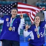 USA's Megan Keller (L) holds the US flag with teammate Danielle Cameranesi after the medal ceremony after winning the women's ice hockey event during the Pyeongchang 2018 Winter Olympic Games at the Gangneung Hockey Centre in Gangneung on February 22, 2018. / AFP PHOTO / JUNG Yeon-JeJUNG YEON-JE/AFP/Getty Images